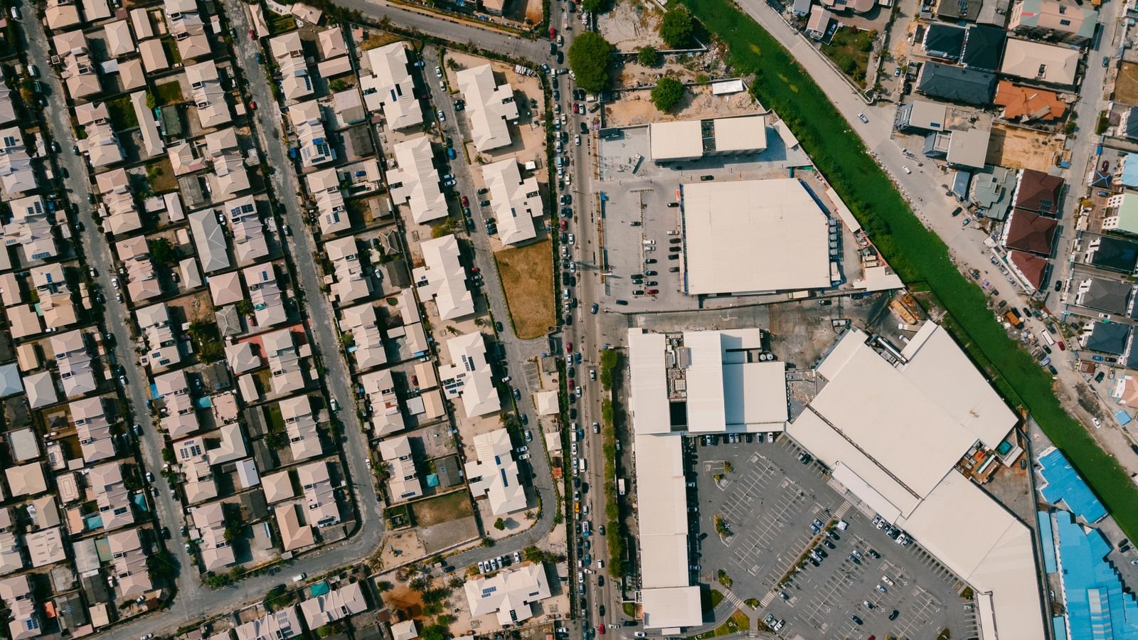 Aerial view of a Nigerian residential estate and commercial area, representing the Abuja property market in 2026