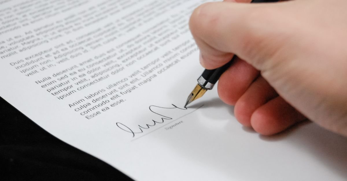 Signing a property title document with a fountain pen