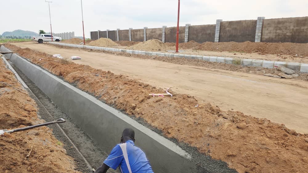 Concrete drainage being cast along the road at Solar City, Apo